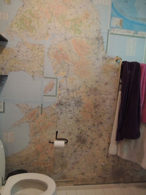 I have no idea how to get a picture of a bathroom. It's your basic bathroom, toilet, shower, sink and lots of maps.
